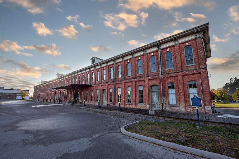 View of the CASO station showcasing its length and size, with red brick walls, arched windows, and a historic architectural style.